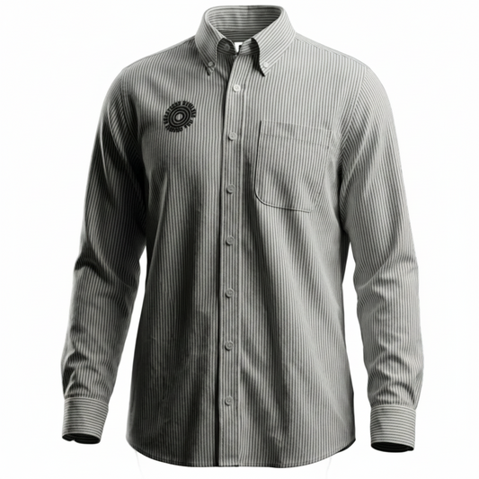 A long-sleeve button-down shirt with fine vertical pinstripes, featuring a chest pocket and a circular black logo patch on the left chest, displayed against a solid white background.